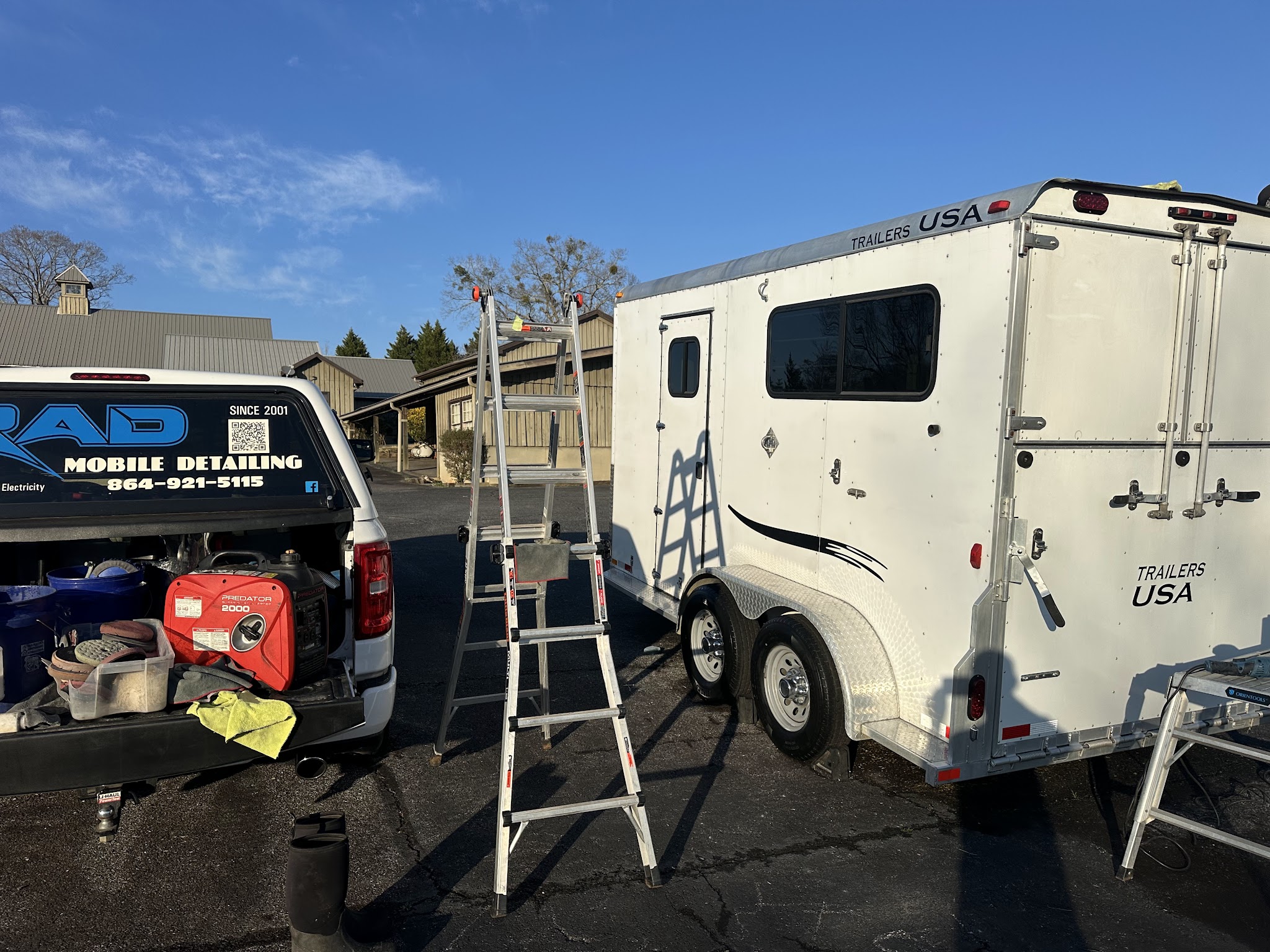 A cargo trailer with the RAD truck and gear set up beside it
