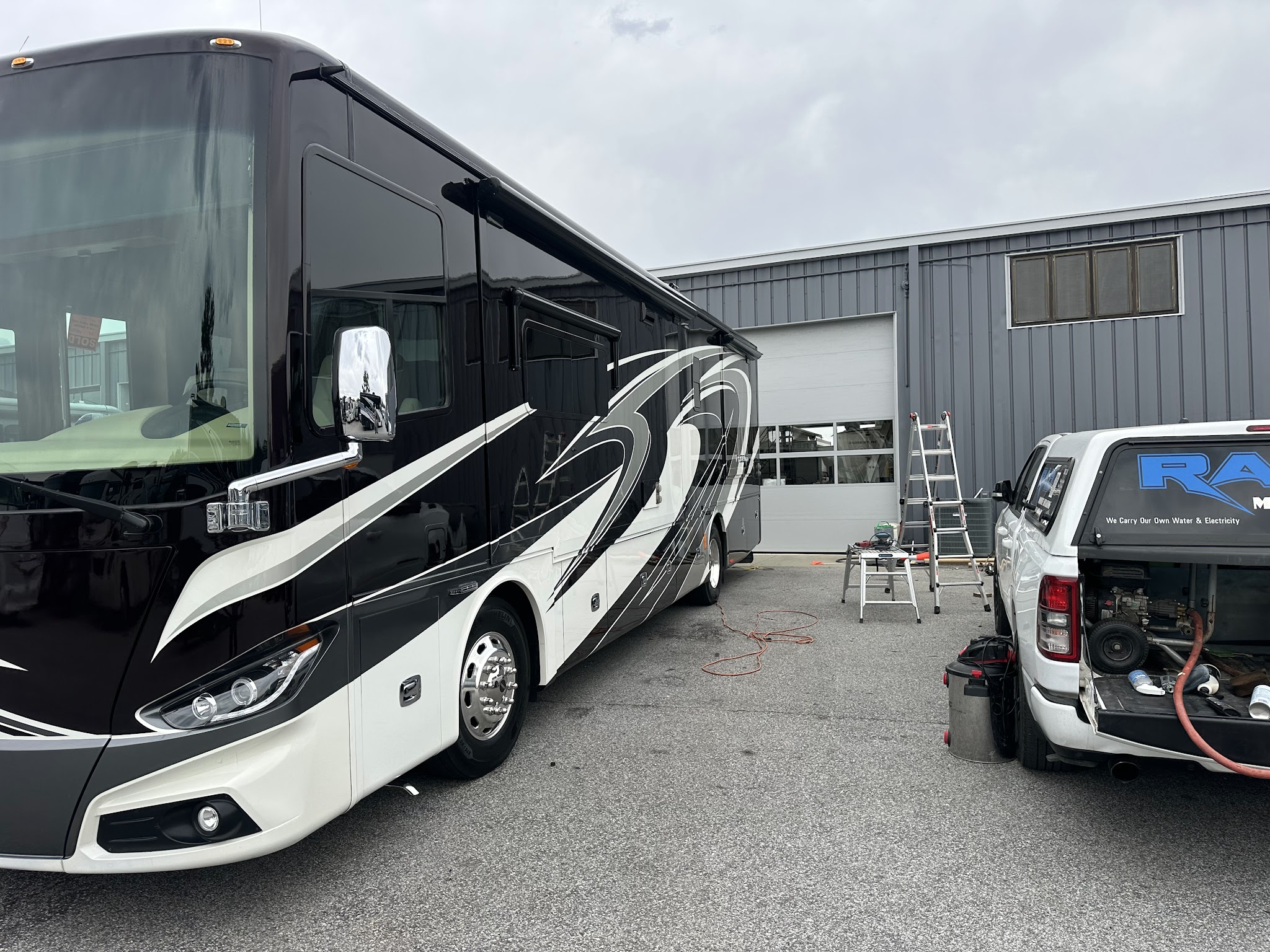 A Tiffin motorcoach in the lot with the RAD truck set up beside it