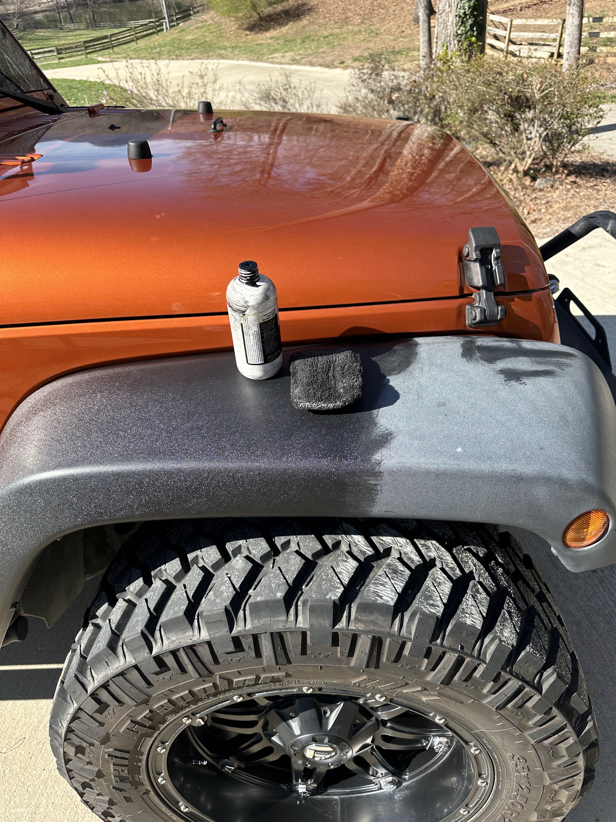 Orange Jeep hood and tyre with the trim half restored