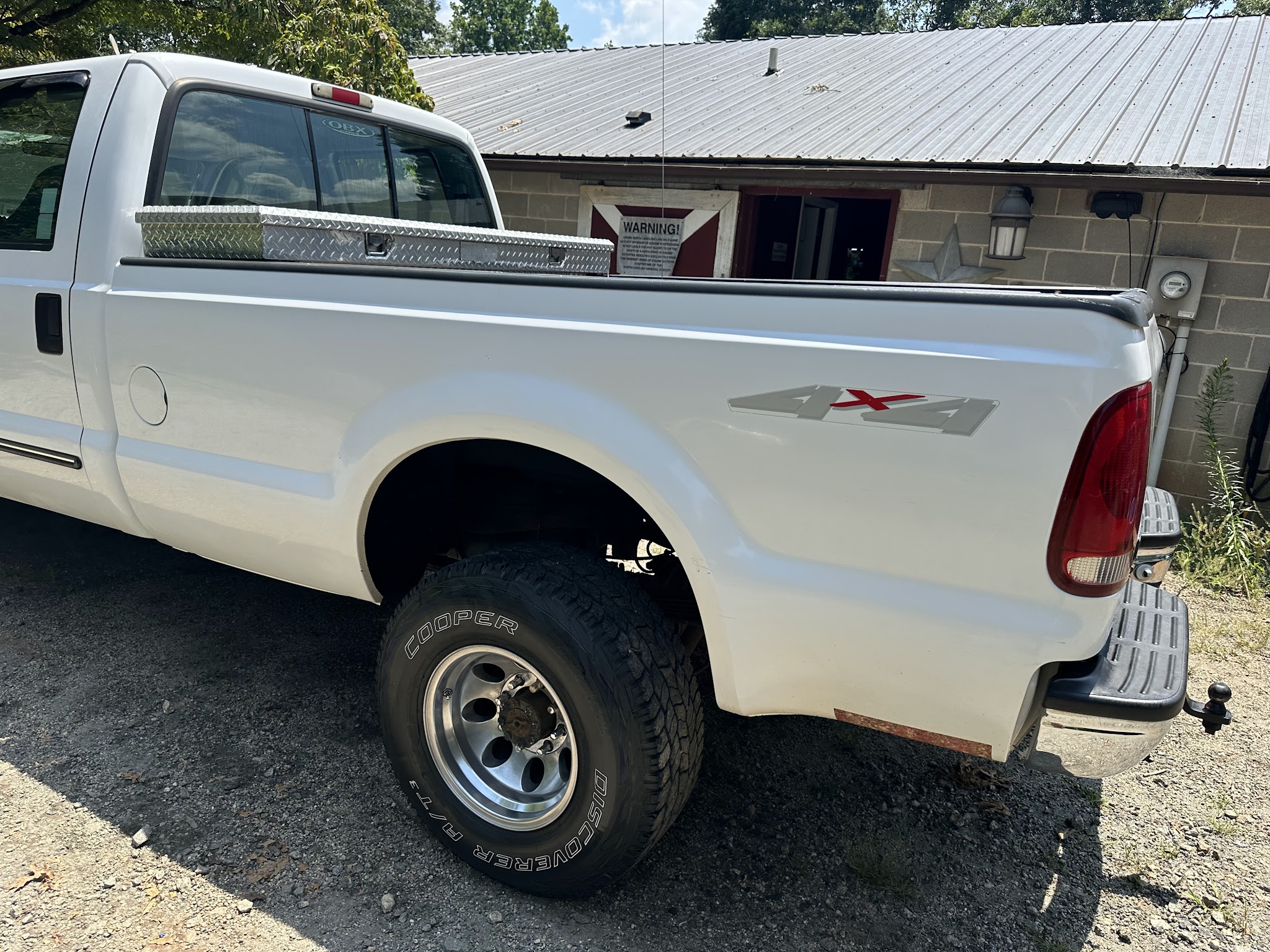 A black classic muscle car in a garage on a lift